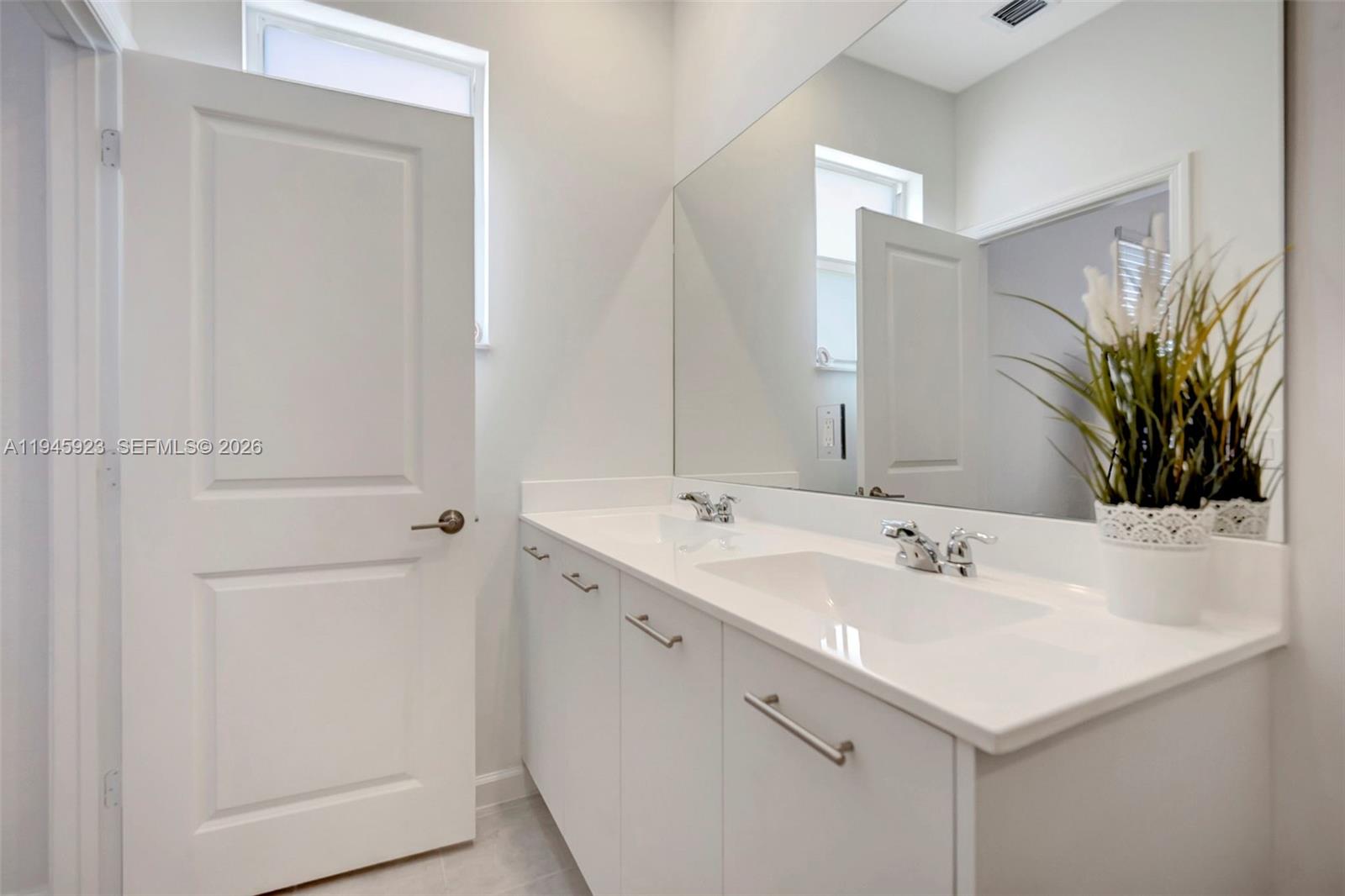 2455 Northwest 119th Street Miami, FL 33167 - Photo 27 of 38 a bathroom with a sink and a mirror