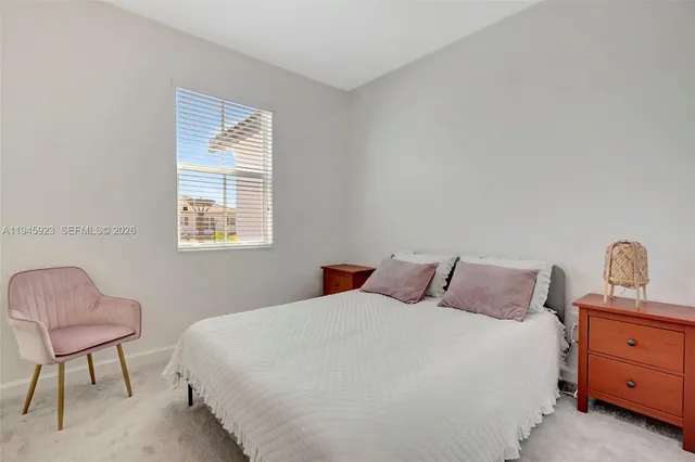 a bedroom with a bed and a chair