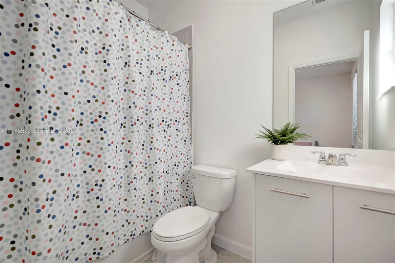 2455 Northwest 119th Street Miami, FL 33167 - Photo 31 of 38 a white toilet sitting next to a bathroom sink