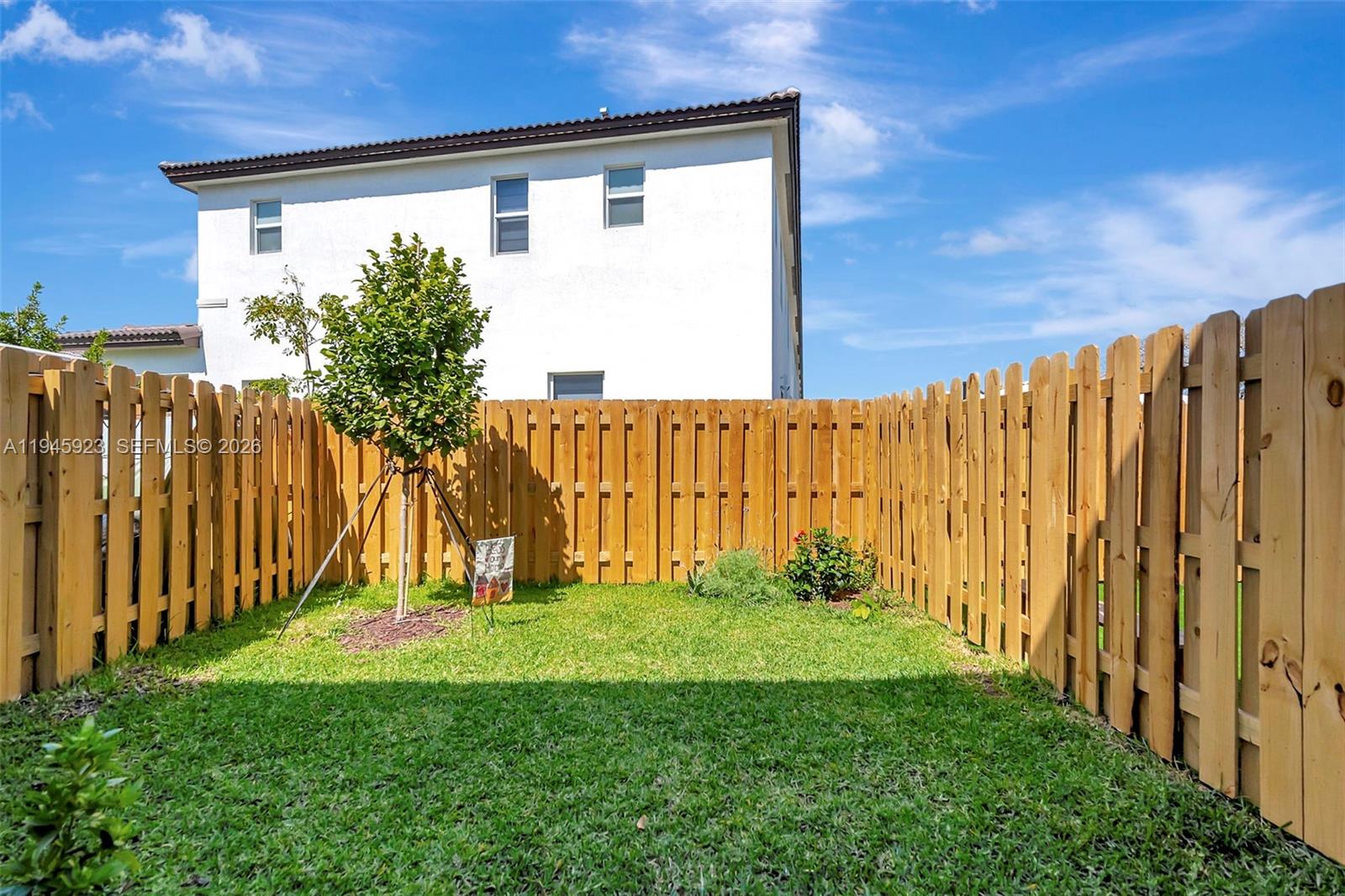 2455 Northwest 119th Street Miami, FL 33167 - Photo 37 of 38 a view of a back yard with a wooden fence