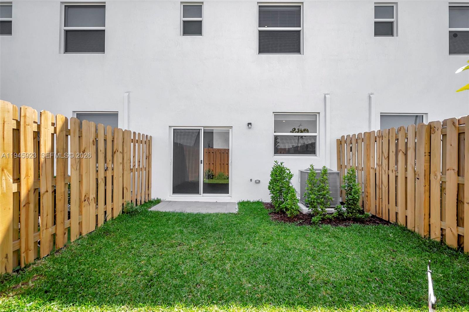 2455 Northwest 119th Street Miami, FL 33167 - Photo 38 of 38 a view of a backyard with potted plants and wooden fence