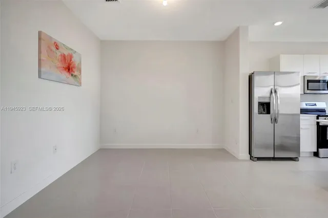 a view of a refrigerator in kitchen