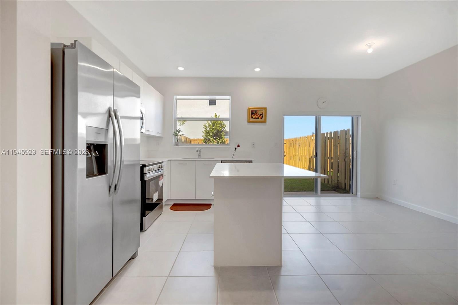 2455 Northwest 119th Street Miami, FL 33167 - Photo 8 of 38 a kitchen with stainless steel appliances a refrigerator and a stove top oven