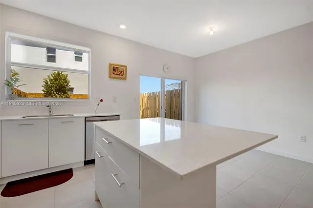 a kitchen with a sink a stove and cabinets