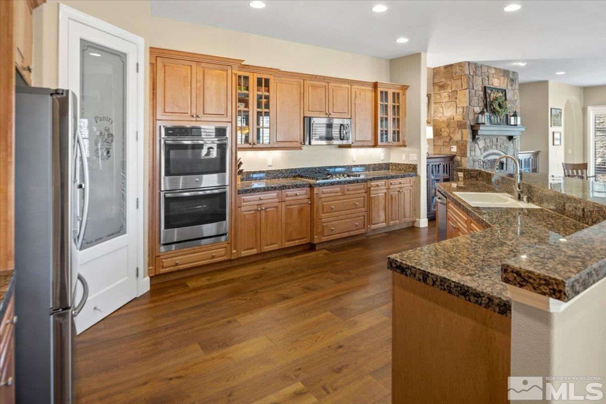 15185 Chateau Avenue Reno, NV 89511 - Photo 11 of 39 a kitchen with stainless steel appliances granite countertop a refrigerator and a sink