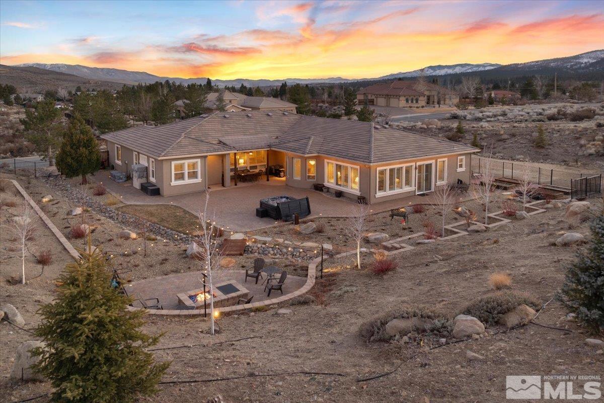 15185 Chateau Avenue Reno, NV 89511 - Photo 19 of 39 a view of a big house with a mountain in the background