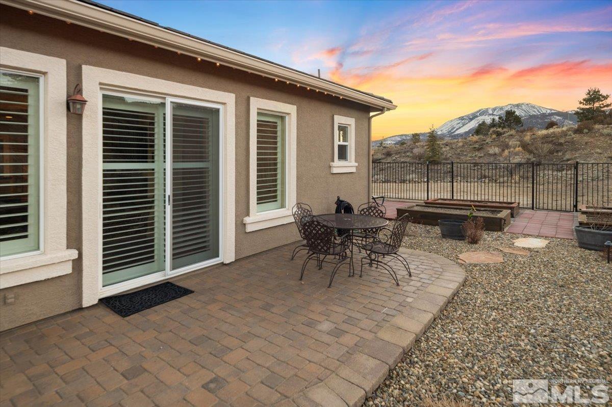 15185 Chateau Avenue Reno, NV 89511 - Photo 22 of 39 a view of a patio with a table and chairs
