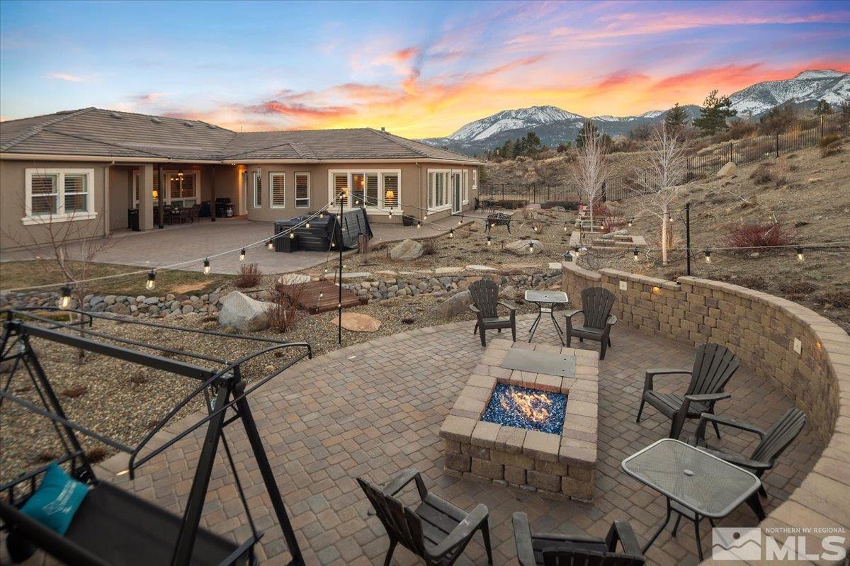 15185 Chateau Avenue Reno, NV 89511 - Photo 31 of 39 a view of a patio with couches table and chairs with wooden floor