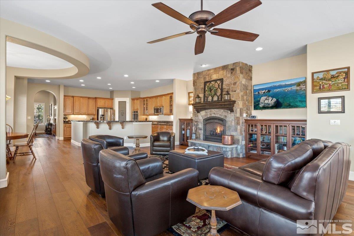 15185 Chateau Avenue Reno, NV 89511 - Photo 9 of 39 a living room with furniture a fireplace and a chandelier