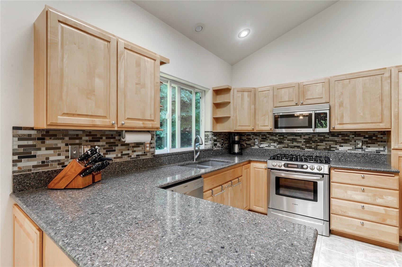 5303 Narbeck Avenue Everett, WA 98203 - Photo 11 of 40 a kitchen with stainless steel appliances granite countertop a sink a stove and cabinets