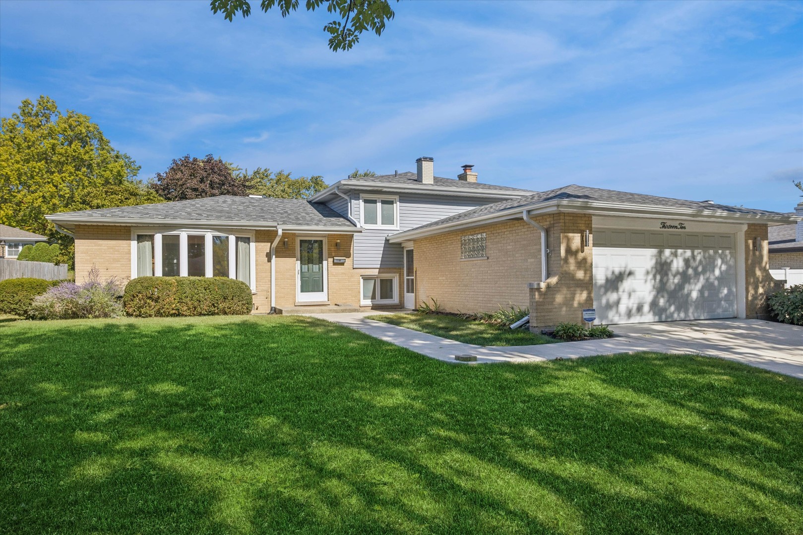 a view of a house with a yard and sitting area