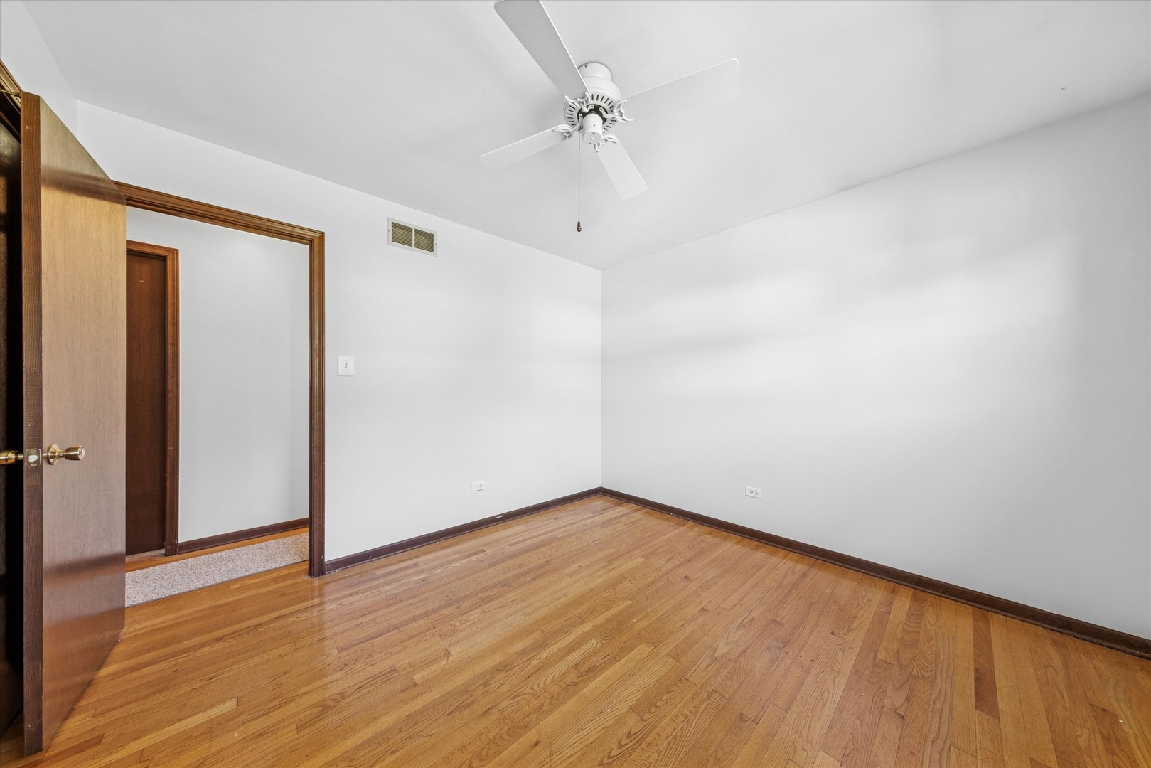 1310 Iroquois Lane Darien, IL 60561 - Photo 15 of 22 a view of an empty room with wooden floor