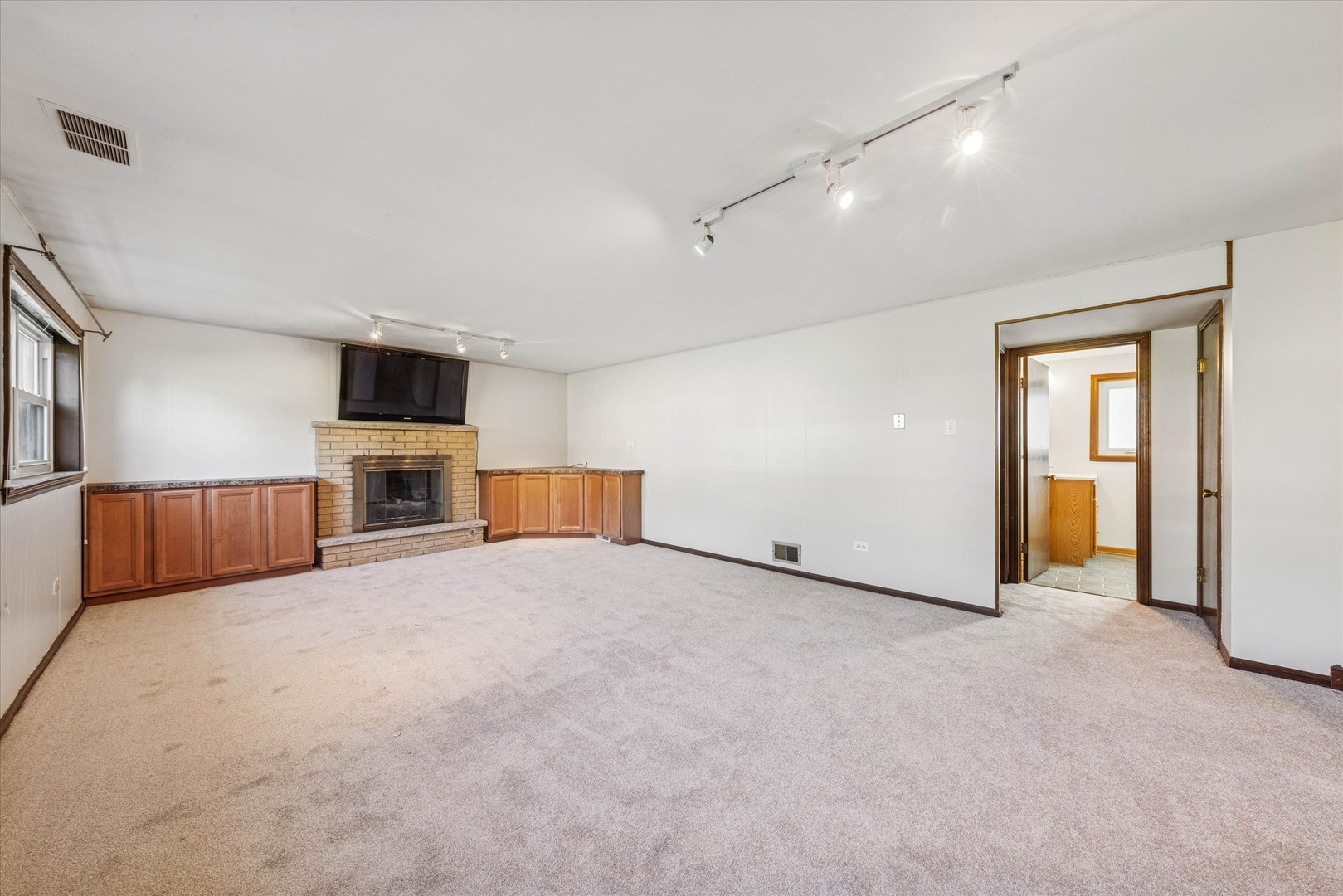 1310 Iroquois Lane Darien, IL 60561 - Photo 16 of 22 an empty room with fireplace and flat screen tv