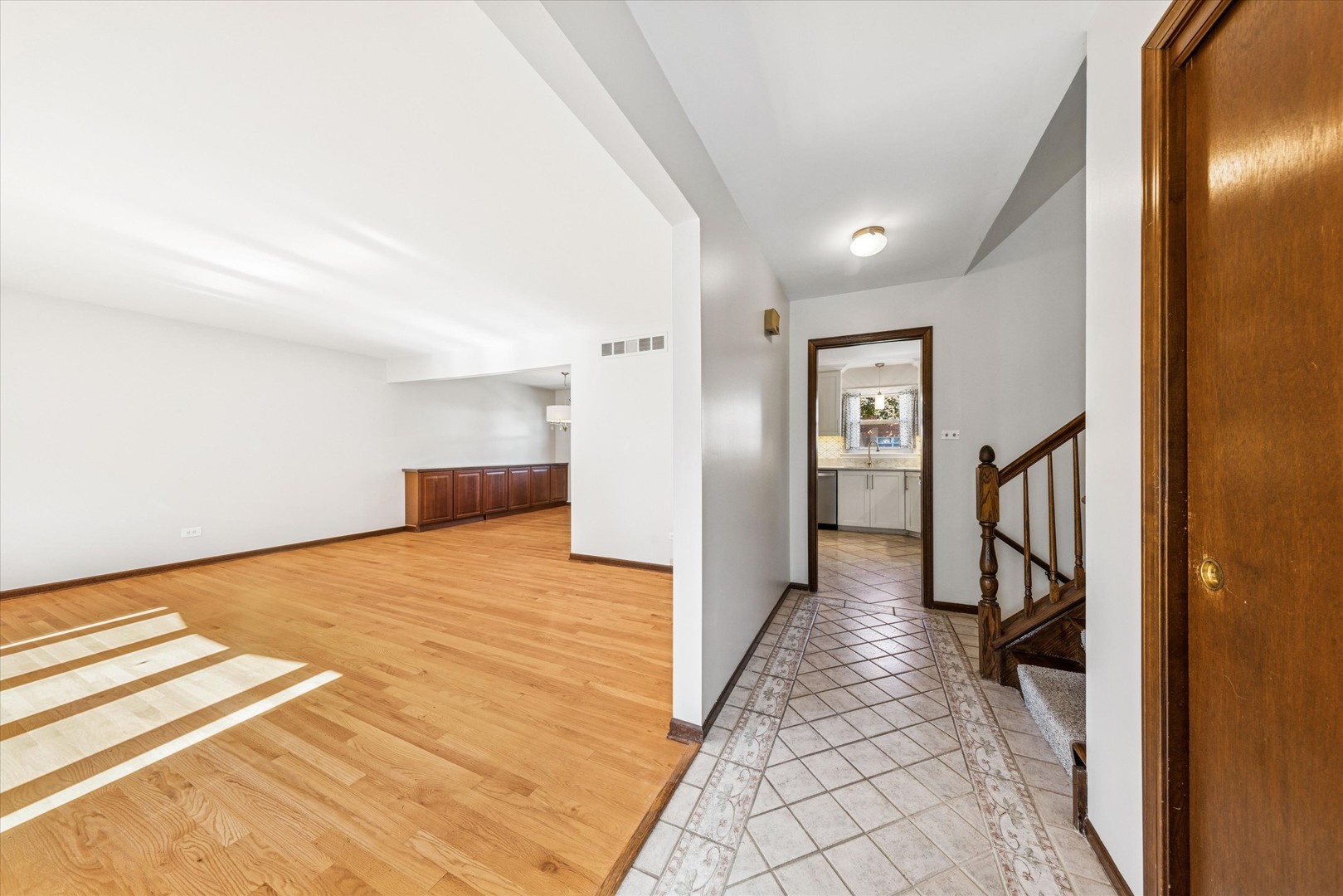 1310 Iroquois Lane Darien, IL 60561 - Photo 2 of 22 a hallway with a bed and a chandelier