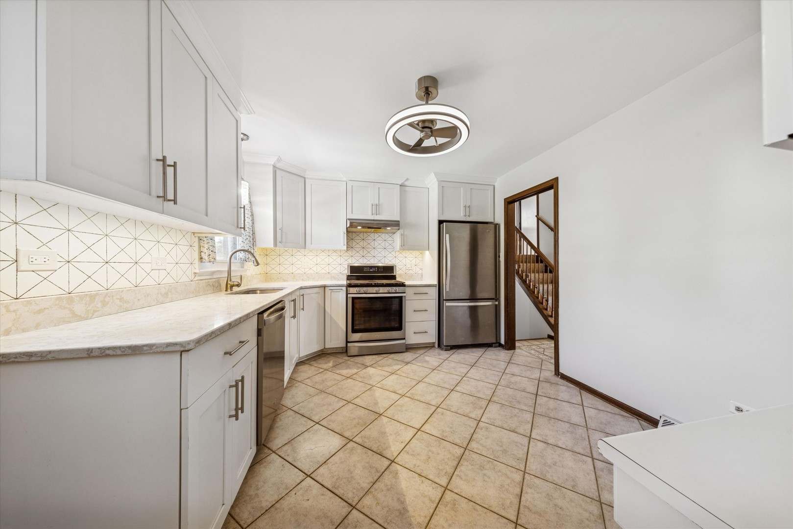 1310 Iroquois Lane Darien, IL 60561 - Photo 7 of 22 a kitchen with a stove cabinets and a refrigerator