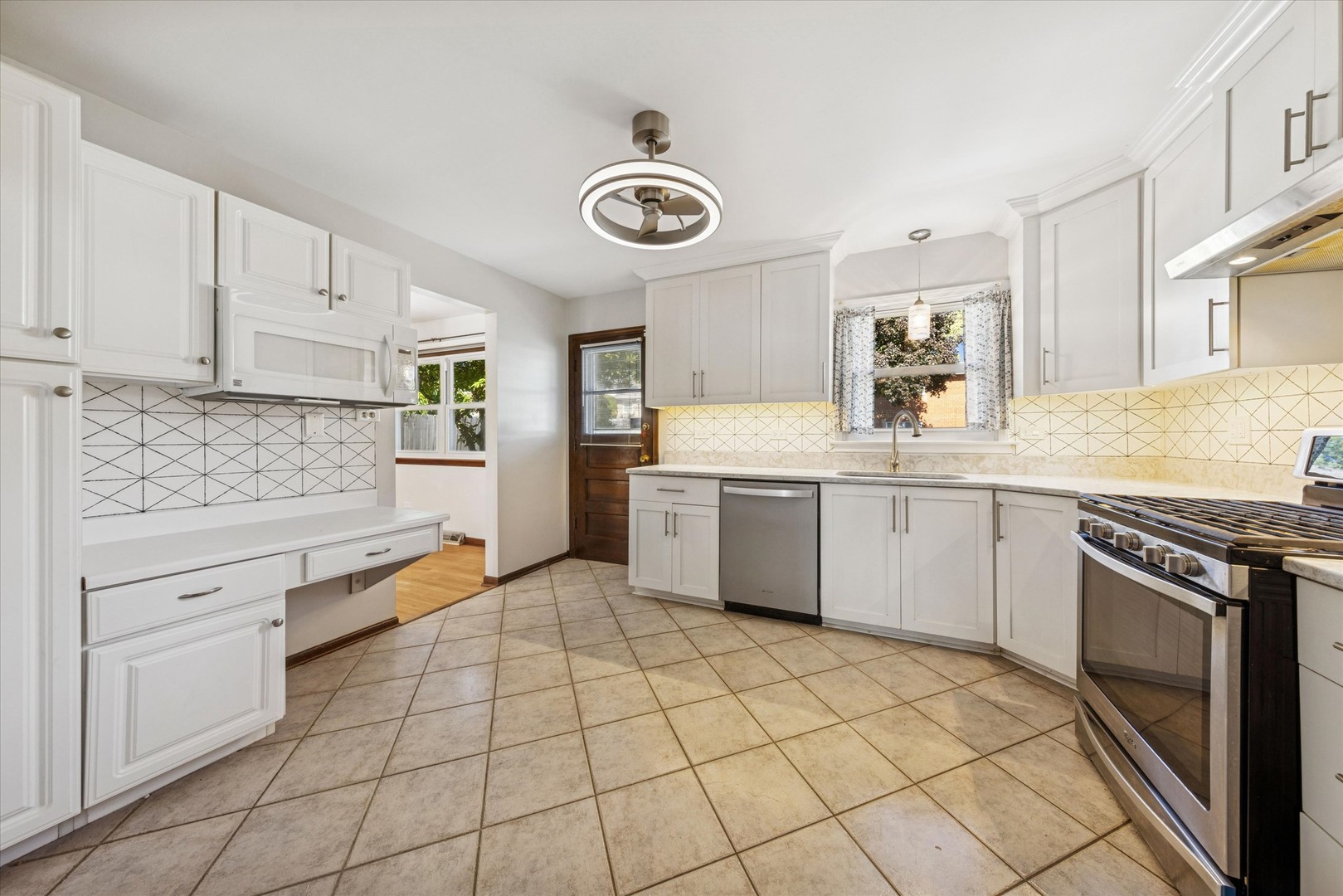 1310 Iroquois Lane Darien, IL 60561 - Photo 8 of 22 a kitchen with a stove sink and cabinets