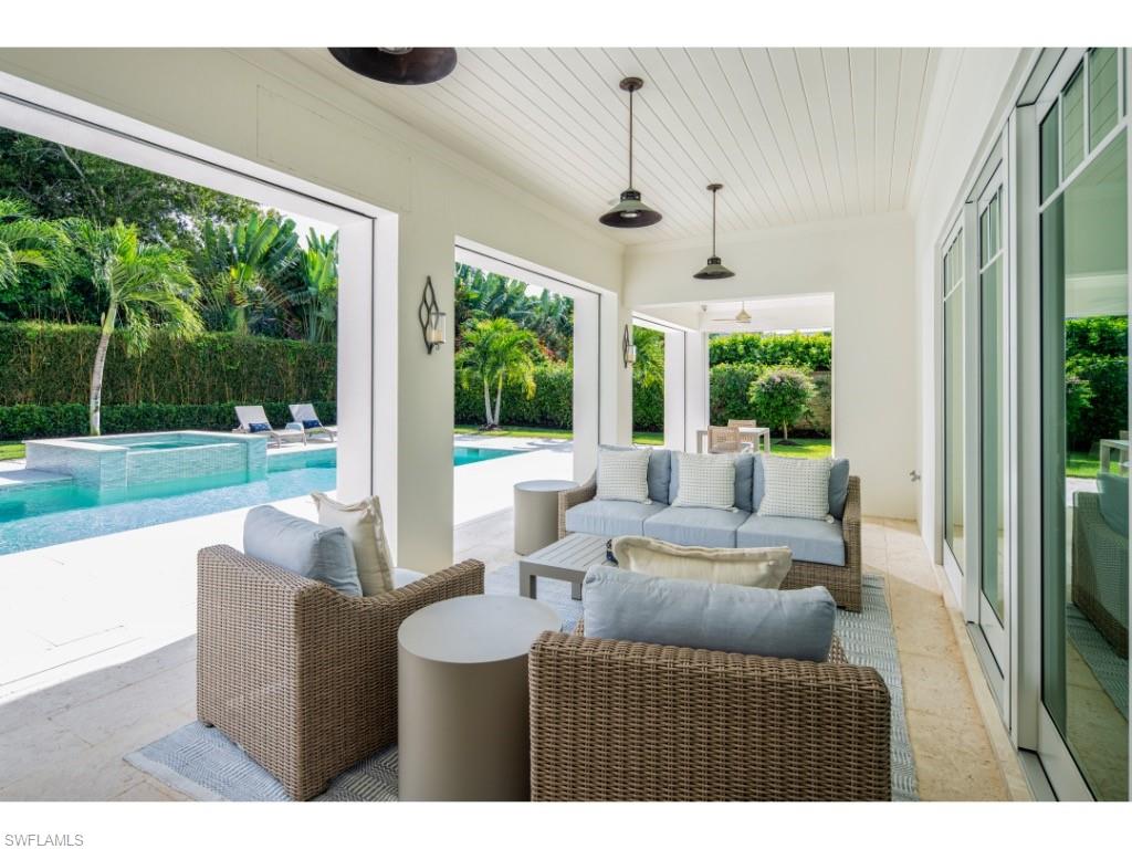 4042 Old Trail Way Naples, FL 34103 - Photo 13 of 20 a living room with furniture and a large window
