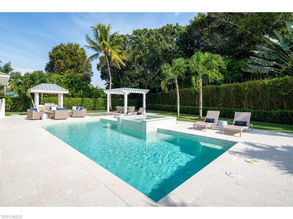 4042 Old Trail Way Naples, FL 34103 - Photo 14 of 20 a view of a swimming pool with a patio