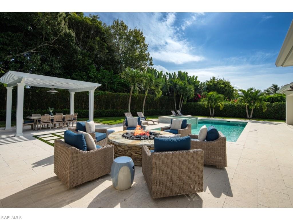 4042 Old Trail Way Naples, FL 34103 - Photo 15 of 20 a view of a patio with couches chairs and a fire pit