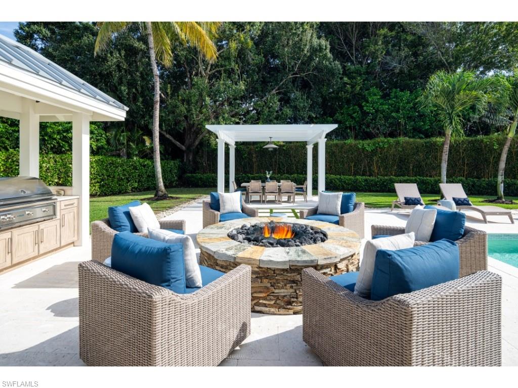 4042 Old Trail Way Naples, FL 34103 - Photo 17 of 20 a view of a patio with couches potted plants and a big yard