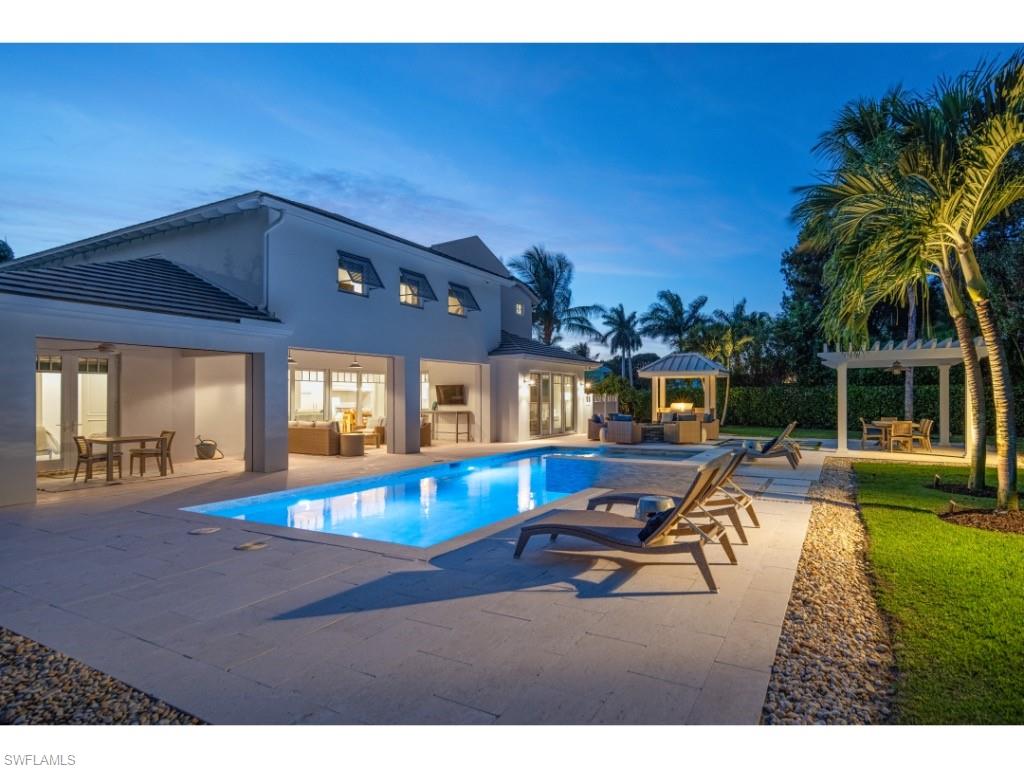 4042 Old Trail Way Naples, FL 34103 - Photo 18 of 20 a view of a house with swimming pool and a yard