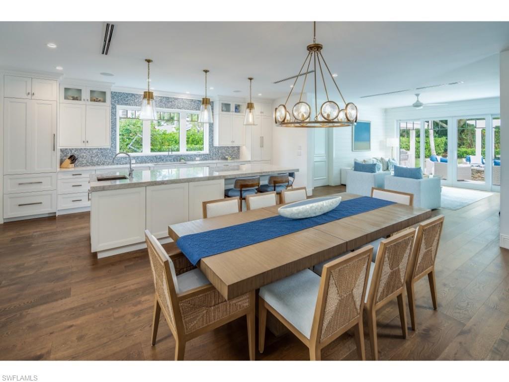 4042 Old Trail Way Naples, FL 34103 - Photo 5 of 20 a dining hall with stainless steel appliances granite countertop wooden floor dining table and chairs