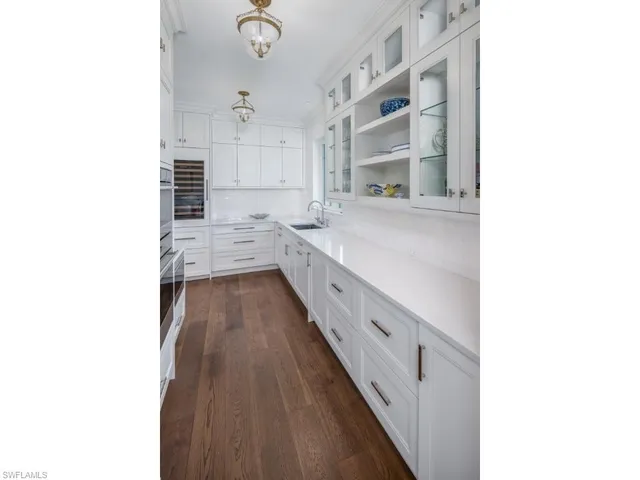 a bathroom with a double vanity sink a mirror and a bathtub