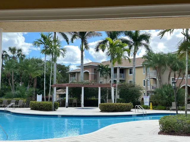 a view of a house with backyard porch and sitting area