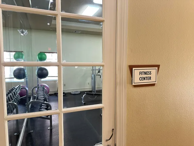 a view of a house with large windows and a table and chairs