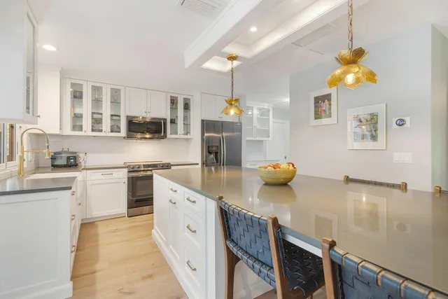 a kitchen with counter top space cabinets and appliances