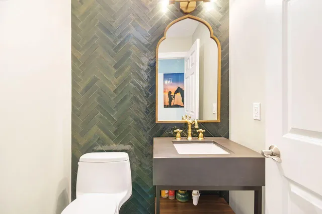 a bathroom with a toilet a sink and mirror