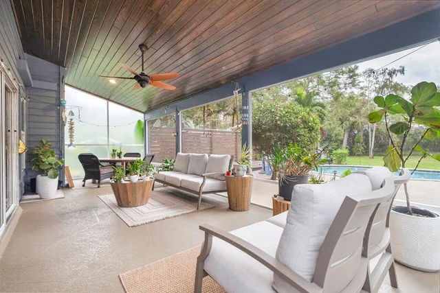 a dining room with furniture a flat screen tv and a fountain