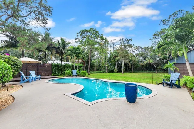 a view of a swimming pool and deck in the outdoor space
