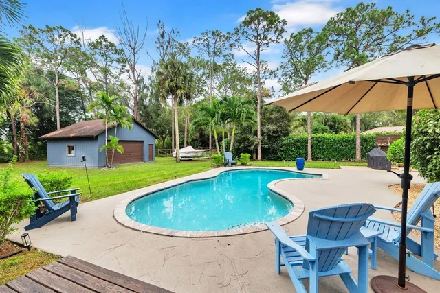a view of a house with backyard porch and sitting area