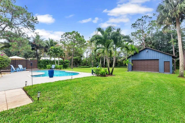 a view of a house with a yard patio and a slide