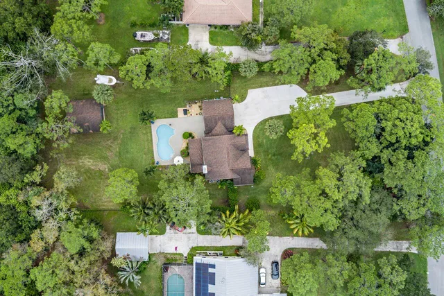 an aerial view of a house with a yard