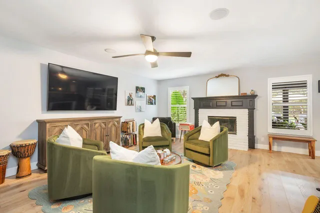 a living room with furniture a flat screen tv and a fireplace