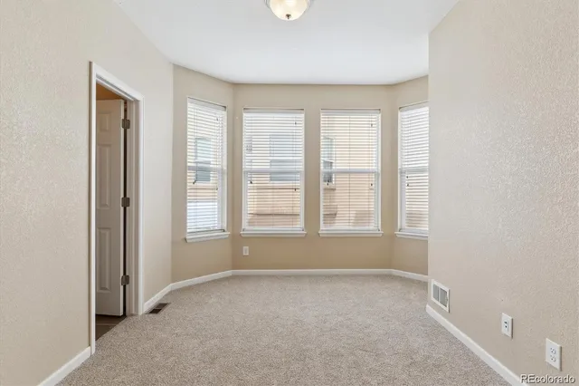 a bedroom with a balcony a bed and a potted plant