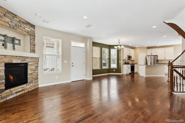 a view of a a dining room with furniture window and wooden floor