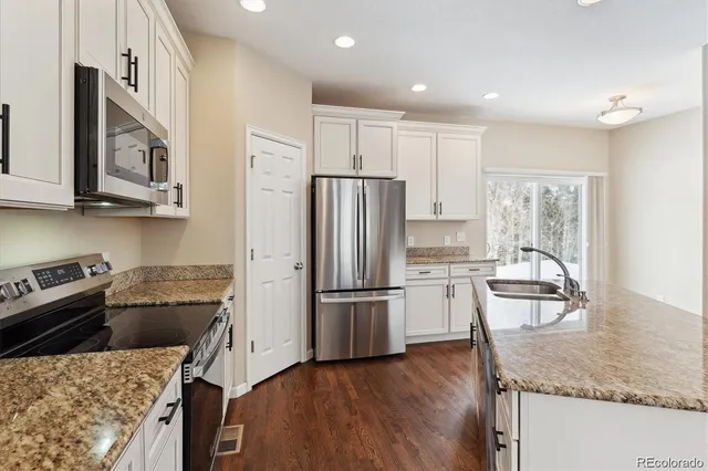 a kitchen with sink and mirror