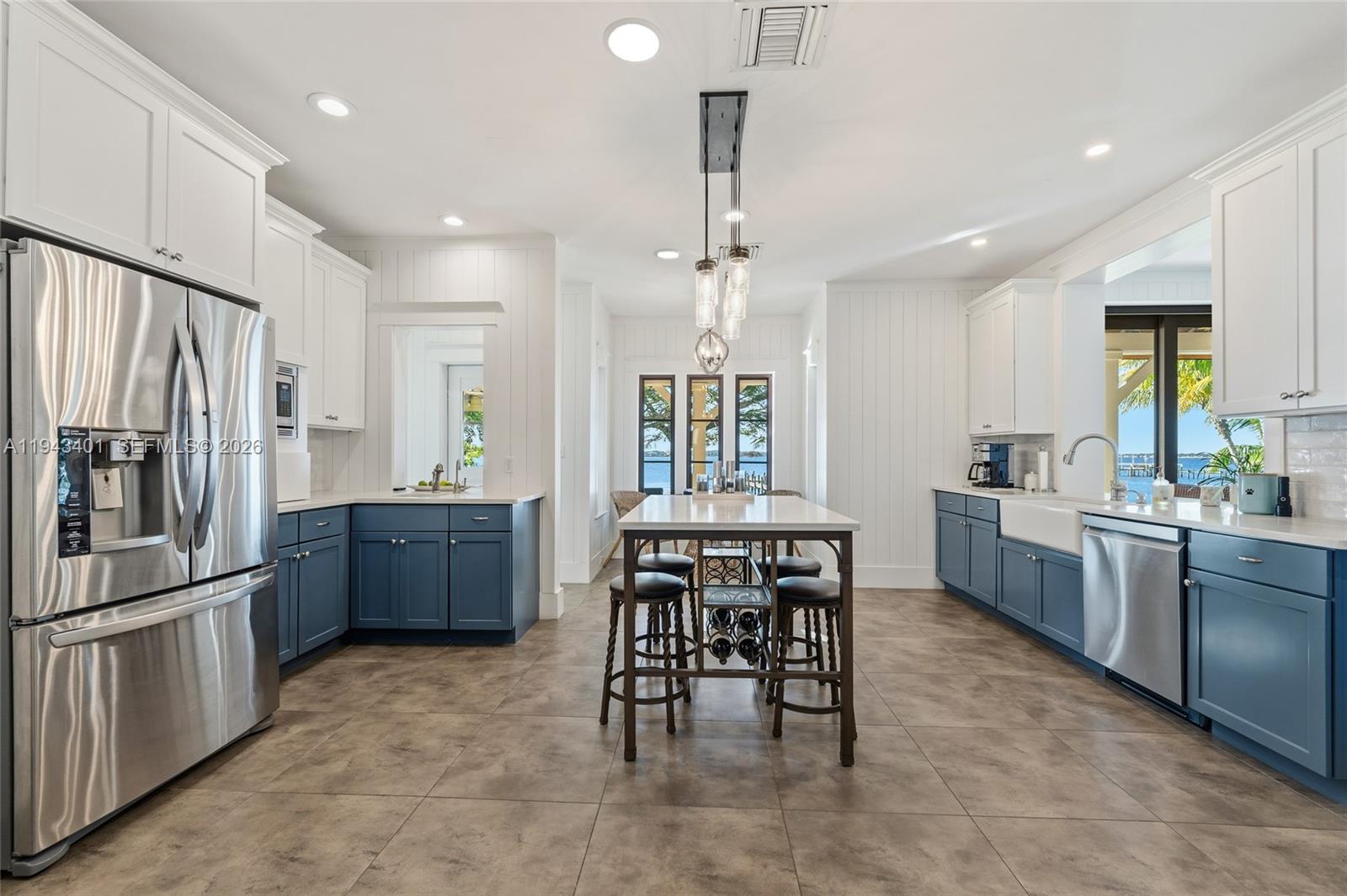 1890 Northwest River Trail Stuart, FL 34994 - Photo 15 of 52 a kitchen with stainless steel appliances granite countertop a stove a sink a refrigerator and a refrigerator