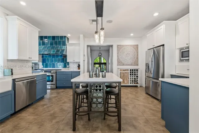 a large kitchen with a table and chairs
