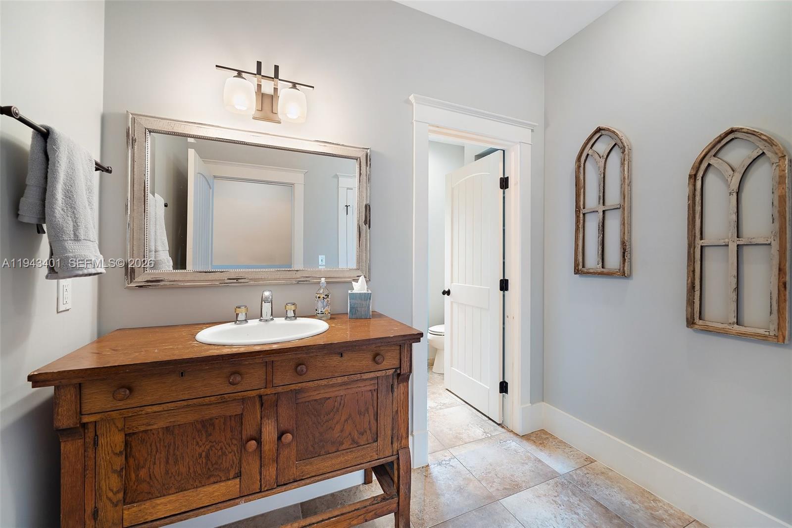 1890 Northwest River Trail Stuart, FL 34994 - Photo 26 of 52 a bathroom with a double vanity sink and a mirror