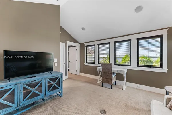 a spacious bedroom with a bed and a large mirror