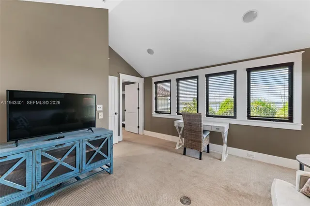 a spacious bedroom with a bed and a large mirror