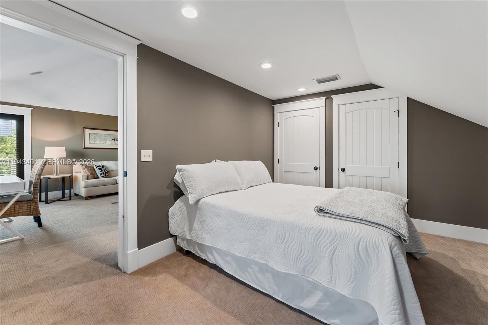 1890 Northwest River Trail Stuart, FL 34994 - Photo 30 of 52 a spacious bedroom with a bed and a large mirror