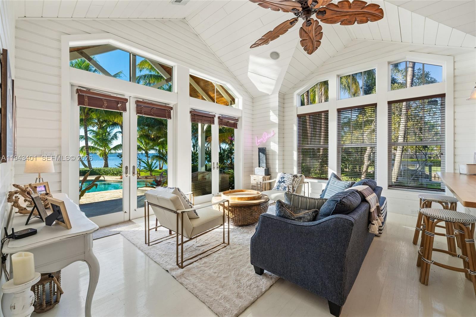 1890 Northwest River Trail Stuart, FL 34994 - Photo 35 of 52 a living room with furniture and floor to ceiling windows