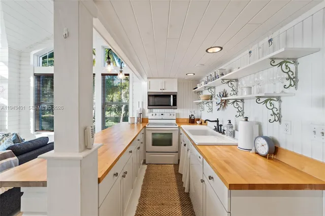 a bed sitting in a spacious bedroom next to a window