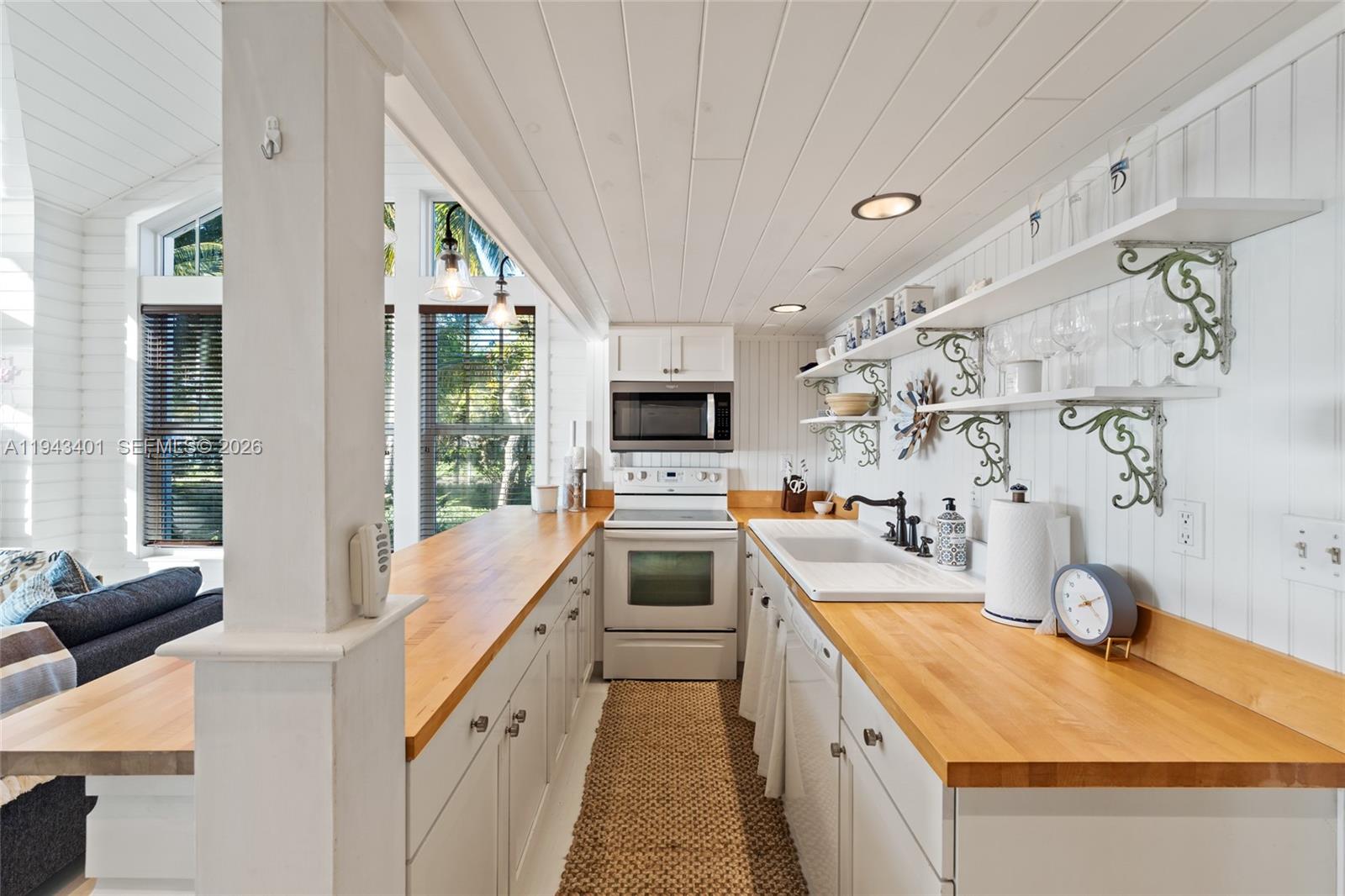 1890 Northwest River Trail Stuart, FL 34994 - Photo 37 of 52 a kitchen with a stove a sink and a refrigerator