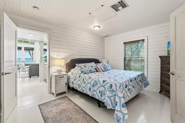 a bedroom with a large bed and a walk in closet